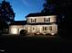 Exterior view of a two-story home at night with a manicured lawn at 10317 Lake Wheeler Rd, Fuquay Varina, NC 27526
