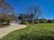 Charming two-story home with a two-car garage, large lawn, and mature landscaping on a sunny day at 10317 Lake Wheeler Rd, Fuquay Varina, NC 27526