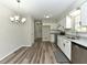 Updated kitchen featuring stainless steel appliances, subway tile backsplash, granite countertops, and wood-look flooring at 10317 Lake Wheeler Rd, Fuquay Varina, NC 27526