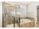 This bathroom features a tub and shower combination with a large window at 104 Bailey Park Ct, Cary, NC 27513