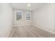 Bright, carpeted bedroom with two windows at 104 Bailey Park Ct, Cary, NC 27513