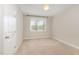 This bedroom features neutral walls, carpet and a window providing natural light at 104 Bailey Park Ct, Cary, NC 27513