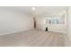 Large bonus room features soft carpet and natural light from the window at 104 Bailey Park Ct, Cary, NC 27513