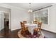 Inviting dining room with hardwood floors, a round table with a lace tablecloth, and natural light at 104 Bailey Park Ct, Cary, NC 27513
