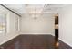 Bright dining area features coffered ceilings, hardwood floors, and modern chandelier at 104 Bailey Park Ct, Cary, NC 27513