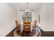 Cozy dining room with hardwood floors, a round table with a lace tablecloth, and natural light at 104 Bailey Park Ct, Cary, NC 27513