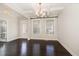 Bright dining area featuring stylish chandelier, hardwood floors, and exterior access at 104 Bailey Park Ct, Cary, NC 27513