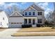 Beautiful two-story home with an attached garage, mature landscaping, and a welcoming front porch at 104 Bailey Park Ct, Cary, NC 27513