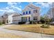 Charming two-story home with a manicured lawn and attached garage on a sunny day at 104 Bailey Park Ct, Cary, NC 27513