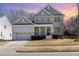 Charming two-story home with manicured lawn and attached two-car garage at 104 Bailey Park Ct, Cary, NC 27513