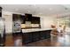 Gourmet kitchen featuring stainless steel appliances, dark wood cabinets, and spacious island at 104 Bailey Park Ct, Cary, NC 27513