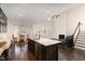 Open concept kitchen/living area with fireplace, island, and dining set at 104 Bailey Park Ct, Cary, NC 27513