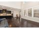 Bright and open living space with hardwood floors leading into the modern kitchen and dining area at 104 Bailey Park Ct, Cary, NC 27513