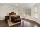 Main bedroom showcasing a bay window, tray ceiling and wooden furniture at 104 Bailey Park Ct, Cary, NC 27513