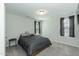 Minimalist bedroom featuring light gray walls, carpet, bedside tables and natural lighting at 105 Village Dr, Broadway, NC 27505