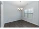 Bright dining room with chandelier, large window, and neutral paint at 105 Village Dr, Broadway, NC 27505
