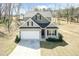 Charming two-story home with a two-car garage, a well-manicured lawn, and a driveway at 105 Village Dr, Broadway, NC 27505