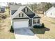 Aerial view of the home's exterior, highlighting the front facade, garage, and driveway at 105 Village Dr, Broadway, NC 27505