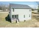 Back exterior of the home features a deck, stairs, grassy area, and neutral siding at 105 Village Dr, Broadway, NC 27505