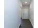 Bright hallway with dark hardwood floors, leading to other areas of the home at 105 Village Dr, Broadway, NC 27505