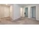 Upstairs hallway with neutral paint and carpet features three entryways at 105 Village Dr, Broadway, NC 27505
