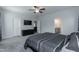 Spacious bedroom with ceiling fan, TV, ensuite bathroom, and walk-in closet at 105 Village Dr, Broadway, NC 27505