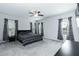 Large bedroom features neutral paint, ceiling fan, curtains, and carpet at 105 Village Dr, Broadway, NC 27505