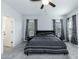 Bright main bedroom with ceiling fan, large windows, and neutral paint at 105 Village Dr, Broadway, NC 27505