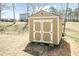 View of the storage shed with double doors and a neutral paint color at 105 Village Dr, Broadway, NC 27505