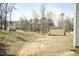 Wide shot of the home's backyard and shed, showing its spacious outdoor setting at 105 Village Dr, Broadway, NC 27505