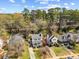 Aerial view showcasing homes with well-maintained lawns, complemented by mature trees and blue skies at 1052 Mills Street, Raleigh, NC 27608