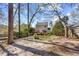 Spacious backyard showcasing a well-maintained lawn, mature trees, and a charming deck at 1052 Mills Street, Raleigh, NC 27608