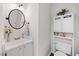Bathroom featuring bright neutral paint, decorative lighting and fixtures, and storage at 1052 Mills Street, Raleigh, NC 27608
