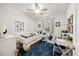 Bright, playful bedroom with blue rug, themed decor, and a comfortable bed next to a sunny window at 1052 Mills Street, Raleigh, NC 27608