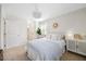 Bedroom featuring neutral carpeting, white walls, light fixtures, and ample natural light at 1052 Mills Street, Raleigh, NC 27608