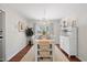 Bright dining room with white wood table and chairs and ample natural light at 1052 Mills Street, Raleigh, NC 27608