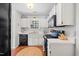 Efficient kitchen with white cabinets, modern appliances, and ample counter space at 1052 Mills Street, Raleigh, NC 27608