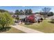 Beautiful brick home with a manicured lawn, mature trees, and circular driveway at 1055 Tilghman Rd, Dunn, NC 28334