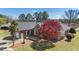 Sprawling brick home featuring mature landscaping, a circular driveway, and an attached garage at 1055 Tilghman Rd, Dunn, NC 28334