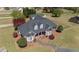 Beautifully landscaped brick home featuring dormer windows and a curved driveway at 1055 Tilghman Rd, Dunn, NC 28334
