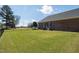 A spacious, well-maintained backyard with a green lawn, offering plenty of room for outdoor activities and relaxation at 1055 Tilghman Rd, Dunn, NC 28334