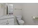 Bathroom with toilet, sink, vanity, mirror, and brushed gold hardware at 1055 Tilghman Rd, Dunn, NC 28334