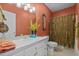 Bathroom featuring a single sink vanity, toilet, shower with gold accents at 1055 Tilghman Rd, Dunn, NC 28334