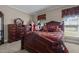 Inviting bedroom with wood furniture, soft lighting, and peaceful ambiance at 1055 Tilghman Rd, Dunn, NC 28334