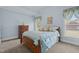 Bedroom with a cozy bed, dresser, carpet, and ample natural light at 1055 Tilghman Rd, Dunn, NC 28334