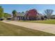 Spacious yard, driveway, and red brick home with black trim at 1055 Tilghman Rd, Dunn, NC 28334