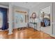 Inviting foyer with hardwood floors, decorative door, and views into main bedroom at 1055 Tilghman Rd, Dunn, NC 28334