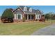 Inviting brick house with dormer windows, manicured lawn, and charming landscaping at 1055 Tilghman Rd, Dunn, NC 28334