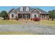 Charming single-Gathering brick home with a landscaped front yard and curved driveway at 1055 Tilghman Rd, Dunn, NC 28334