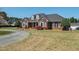 Attractive single-Gathering brick home with landscaped lawn and curved driveway at 1055 Tilghman Rd, Dunn, NC 28334